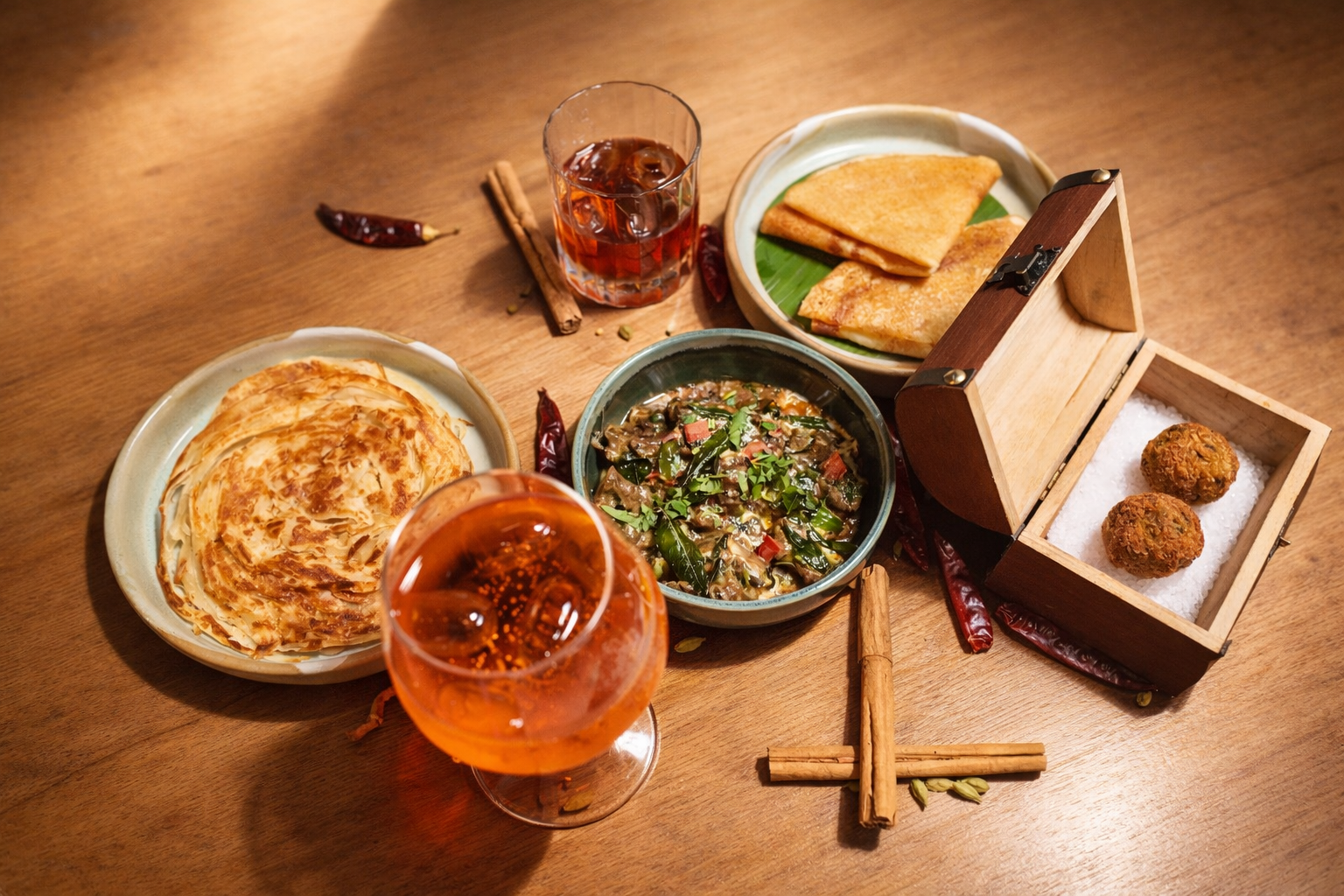 Paneer Tikka skewer with grilled capsicum and onion on a banana leaf, served with chutneys and a rose drink